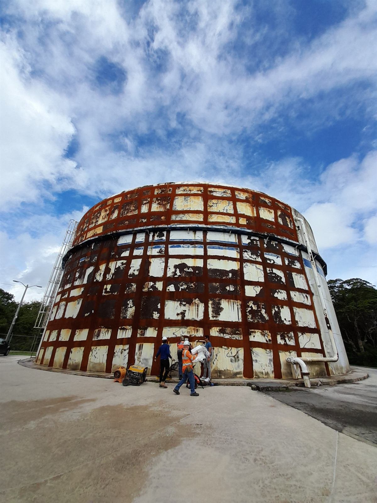 Astumbo water tank before repair, with heavy rust across the shell