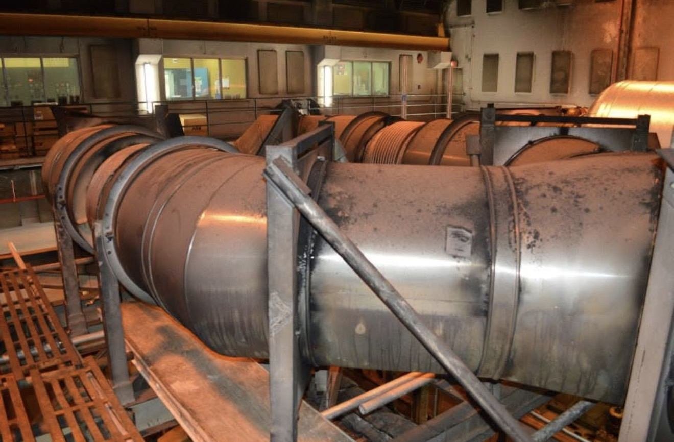 Large stainless steel exhaust duct sections inside a power plant