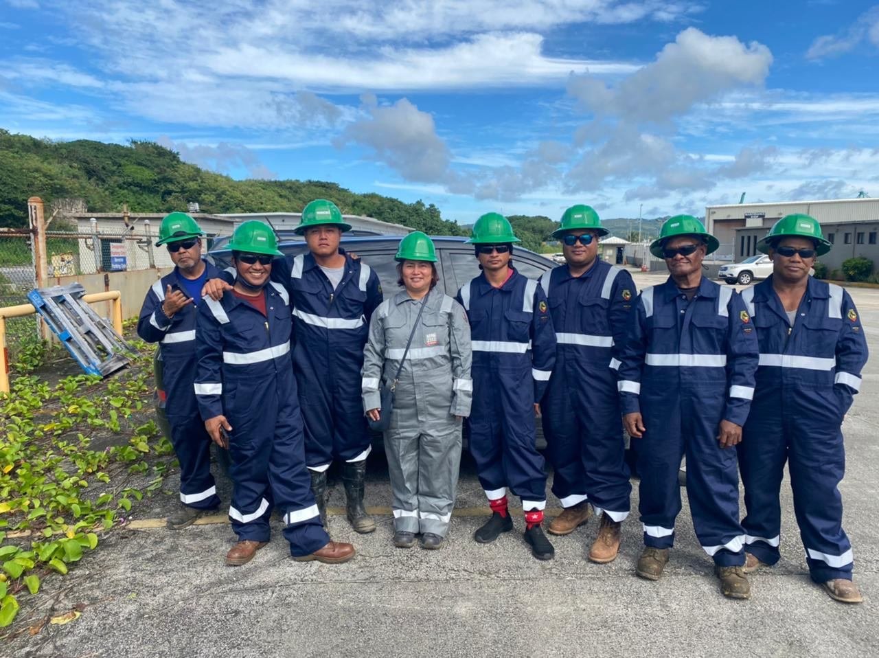The RDE Mechanical Solutions crew in navy coveralls and green hard hats